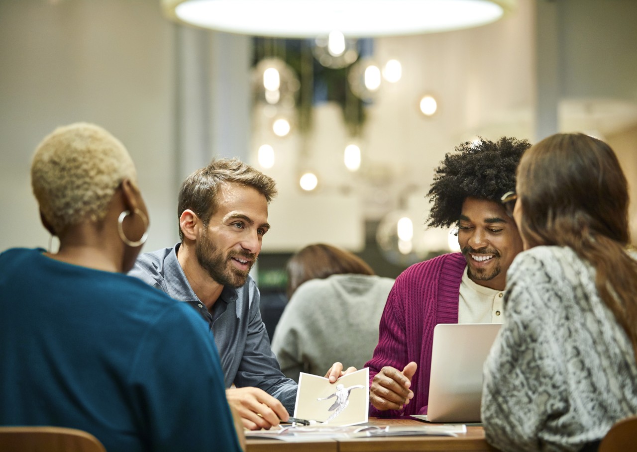 Multi-ethnic coworkers discussing in office